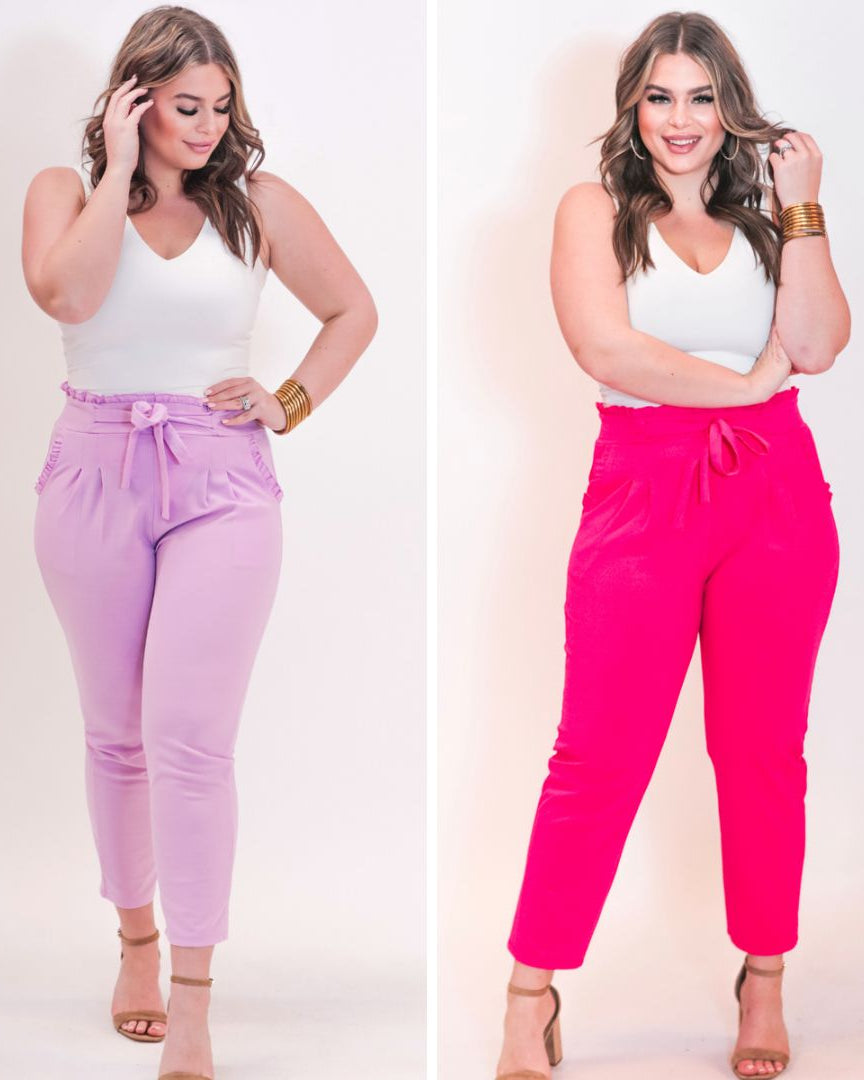 high-waisted paper-bag silhouette pants with a ruffle trim and sash tie, lightweight drapey fabric, straight legs, side pockets polished with a flirty ruffle, and unlined for breezy comfort in lavender and pink