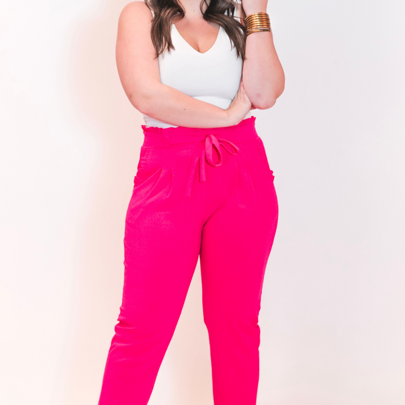 high-waisted paper-bag silhouette pants with a ruffle trim and sash tie, lightweight drapey fabric, straight legs, side pockets polished with a flirty ruffle, and unlined for breezy comfort in pink