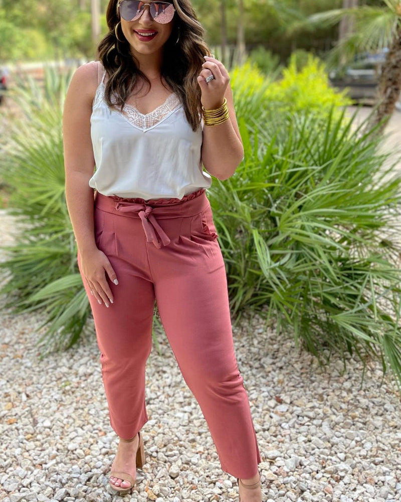 high-waisted paper-bag silhouette pants with a ruffle trim and sash tie, lightweight drapey fabric, straight legs, side pockets polished with a flirty ruffle, and unlined for breezy comfort in rose