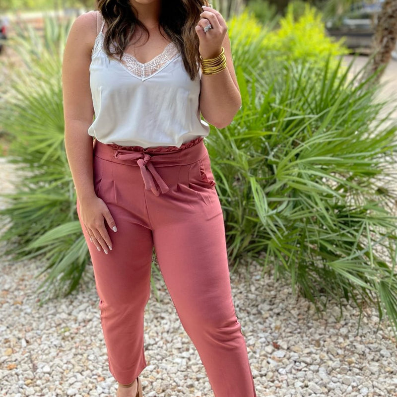 high-waisted paper-bag silhouette pants with a ruffle trim and sash tie, lightweight drapey fabric, straight legs, side pockets polished with a flirty ruffle, and unlined for breezy comfort in rose