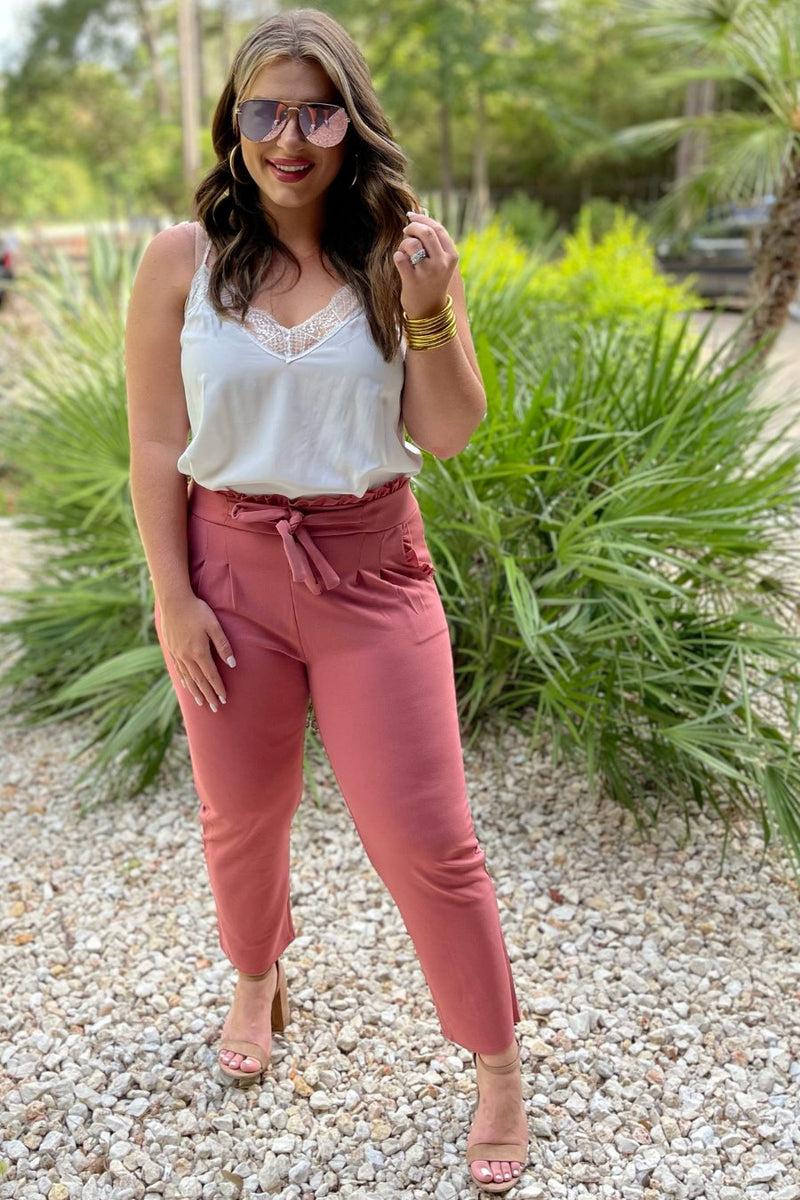 high-waisted paper-bag silhouette pants with a ruffle trim and sash tie, lightweight drapey fabric, straight legs, side pockets polished with a flirty ruffle, and unlined for breezy comfort in rose