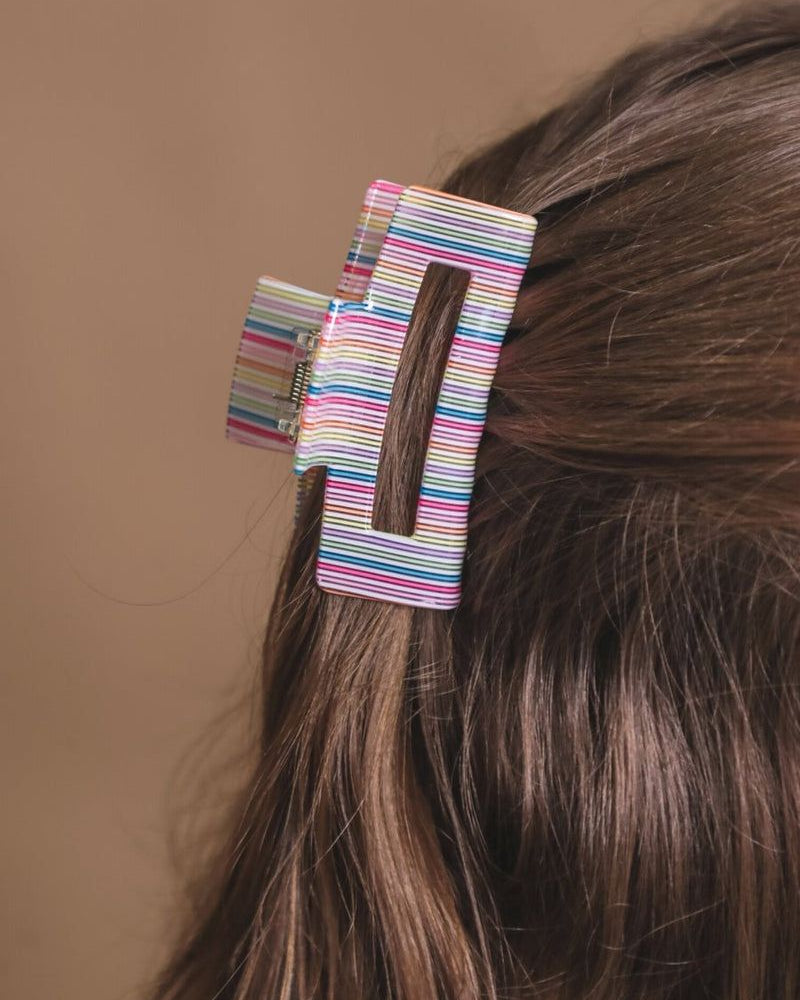 a small acrylic claw clip with a gentle grip that reduces breakage while providing a secure hold in multi