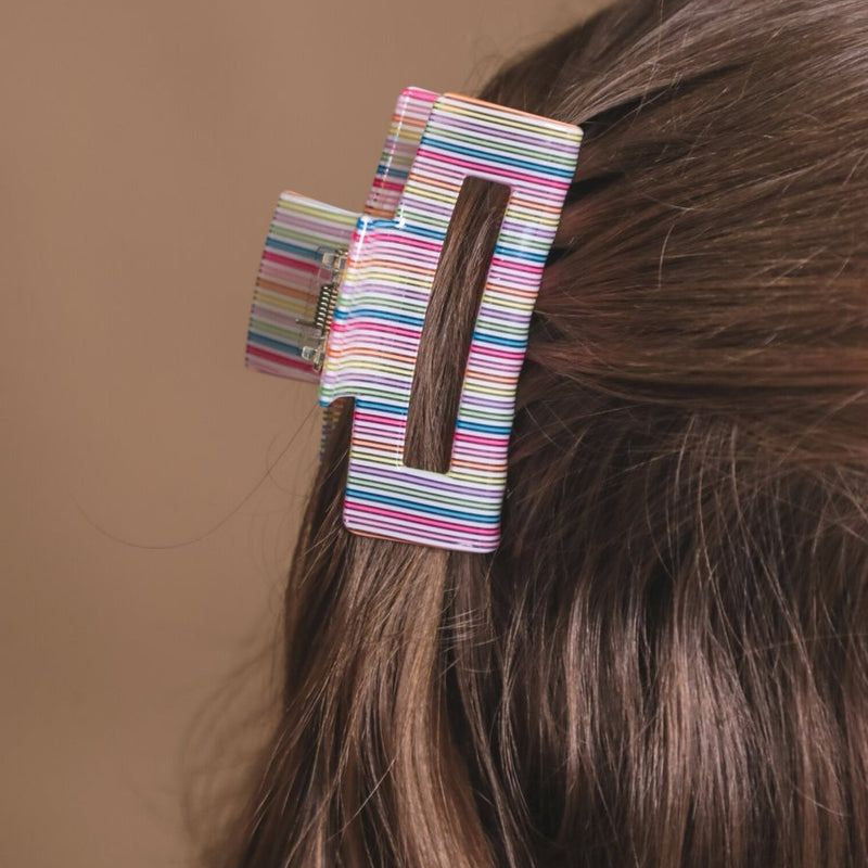 a small acrylic claw clip with a gentle grip that reduces breakage while providing a secure hold in multi