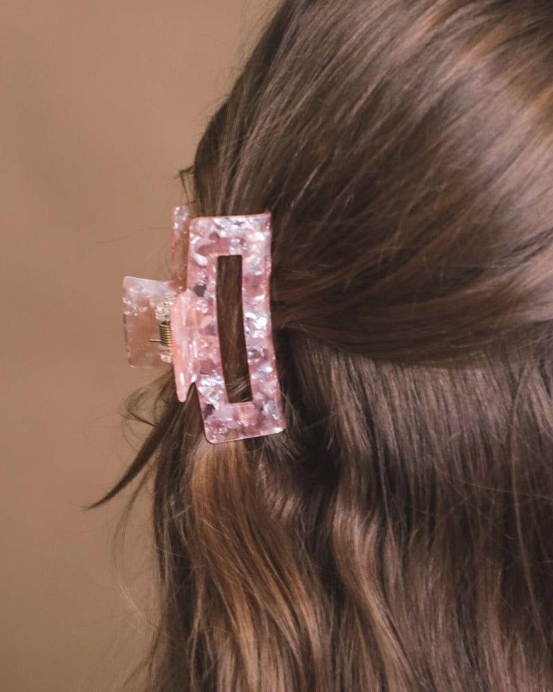 a small acrylic claw clip with a gentle grip that reduces breakage while providing a secure hold in pink