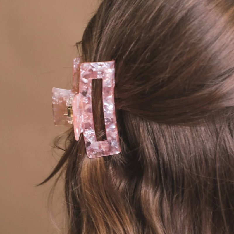 a small acrylic claw clip with a gentle grip that reduces breakage while providing a secure hold in pink