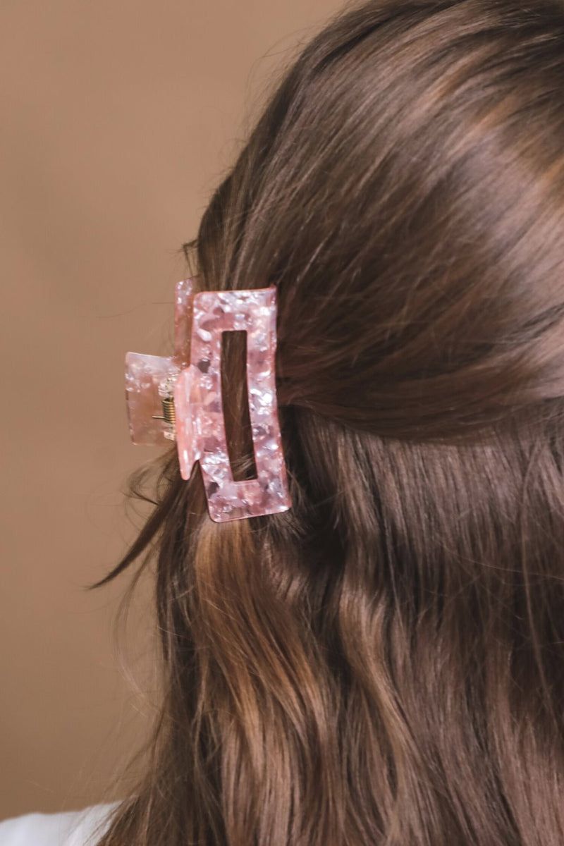 a small acrylic claw clip with a gentle grip that reduces breakage while providing a secure hold in pink
