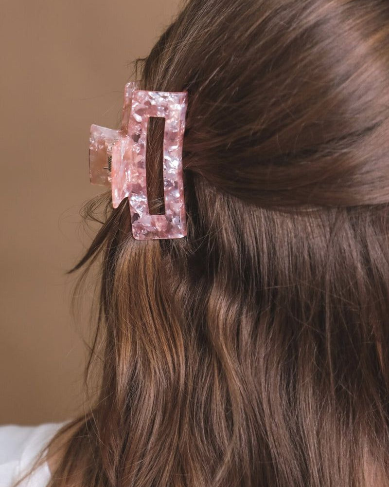 a small acrylic claw clip with a gentle grip that reduces breakage while providing a secure hold in pink