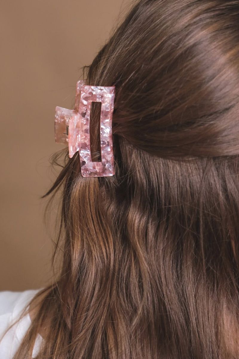 a small acrylic claw clip with a gentle grip that reduces breakage while providing a secure hold in pink