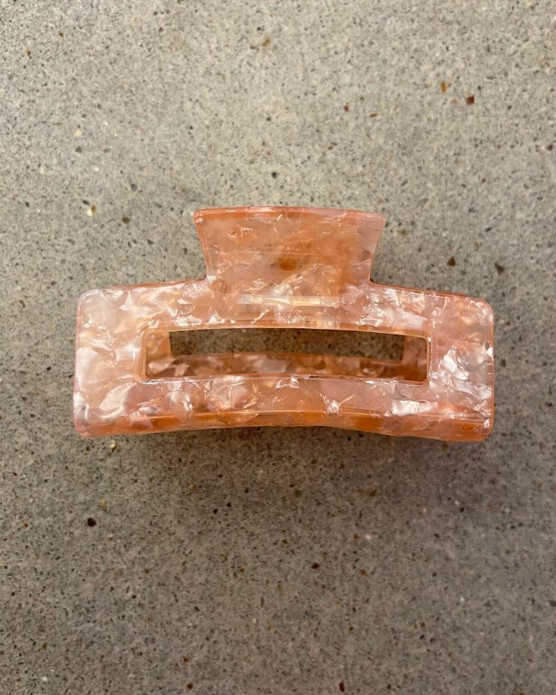 a small acrylic claw clip with a gentle grip that reduces breakage while providing a secure hold in pink