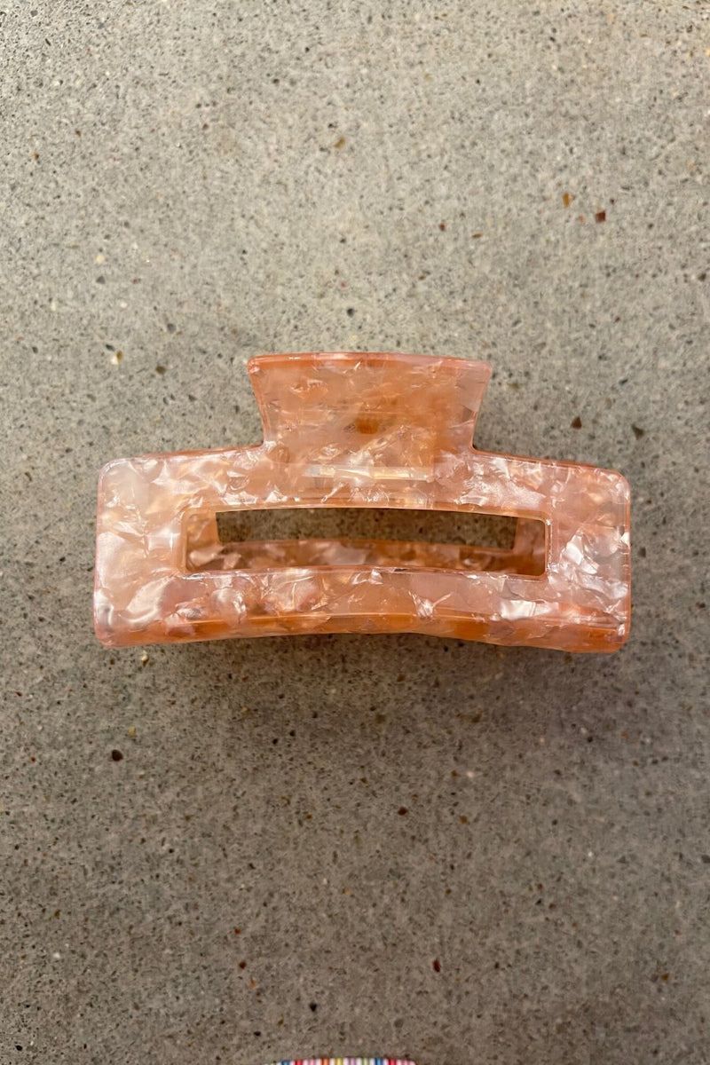 a small acrylic claw clip with a gentle grip that reduces breakage while providing a secure hold in pink