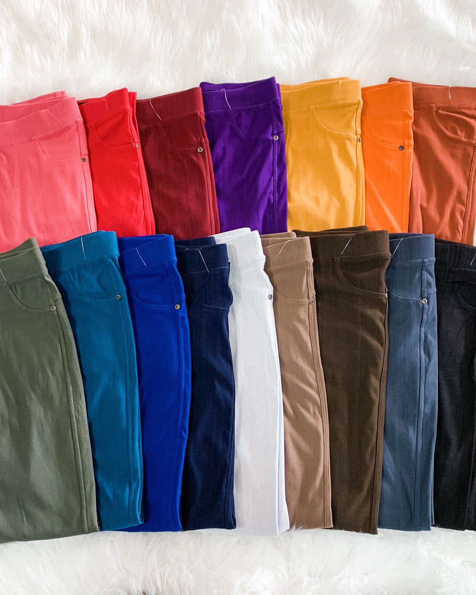 solid pull-on style leggings made of premium stretch fabric thicker than regular leggings, an elastic waistband, double back pockets, and a unique stripe detailing on the inside in coral, red, burgundy, purple, mustard, orange, rust, olive, teal, royal blue, navy, white, mocha, brown, charcoal, and black