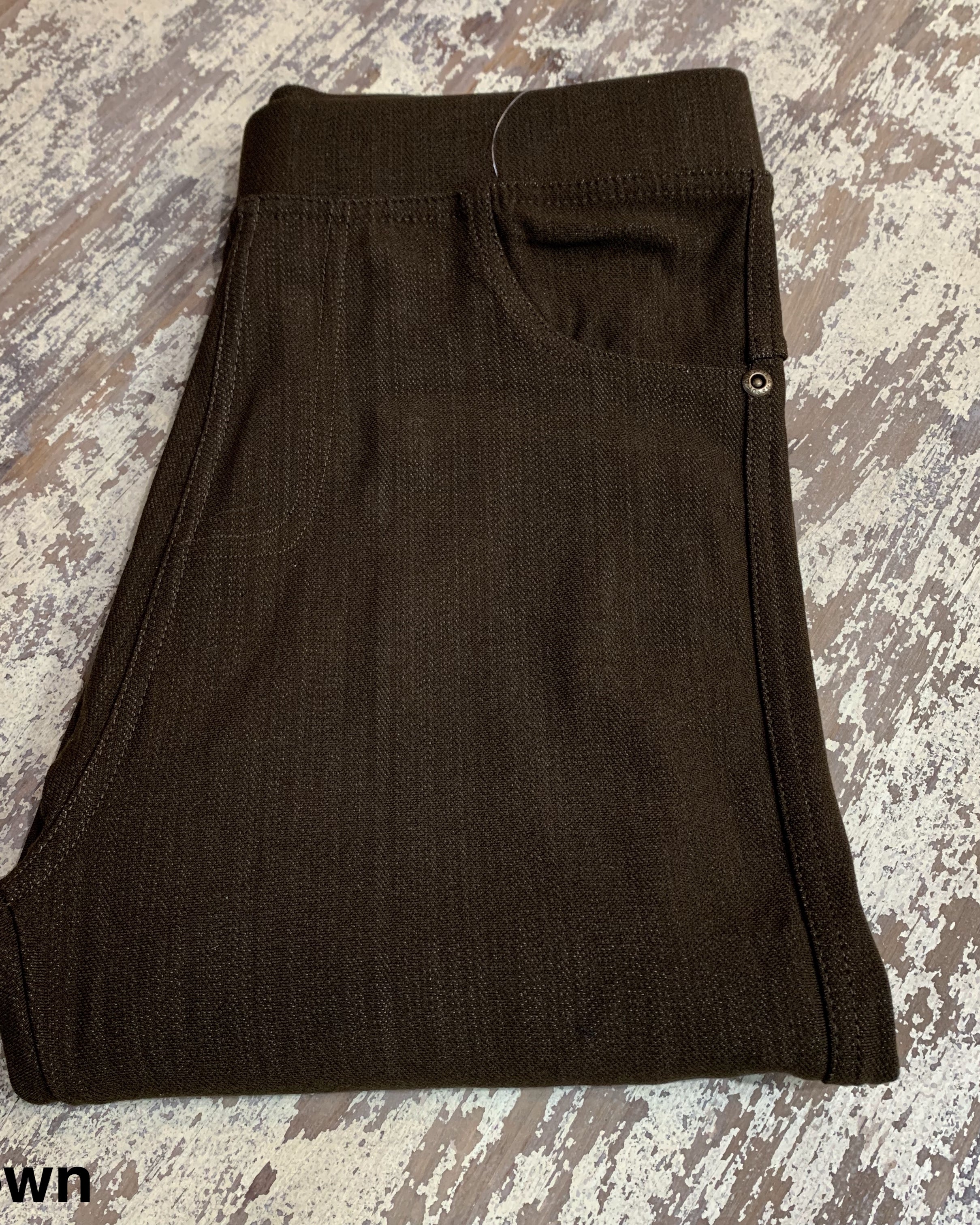 solid pull-on style leggings made of premium stretch fabric thicker than regular leggings, an elastic waistband, double back pockets, and a unique stripe detailing on the inside in brown