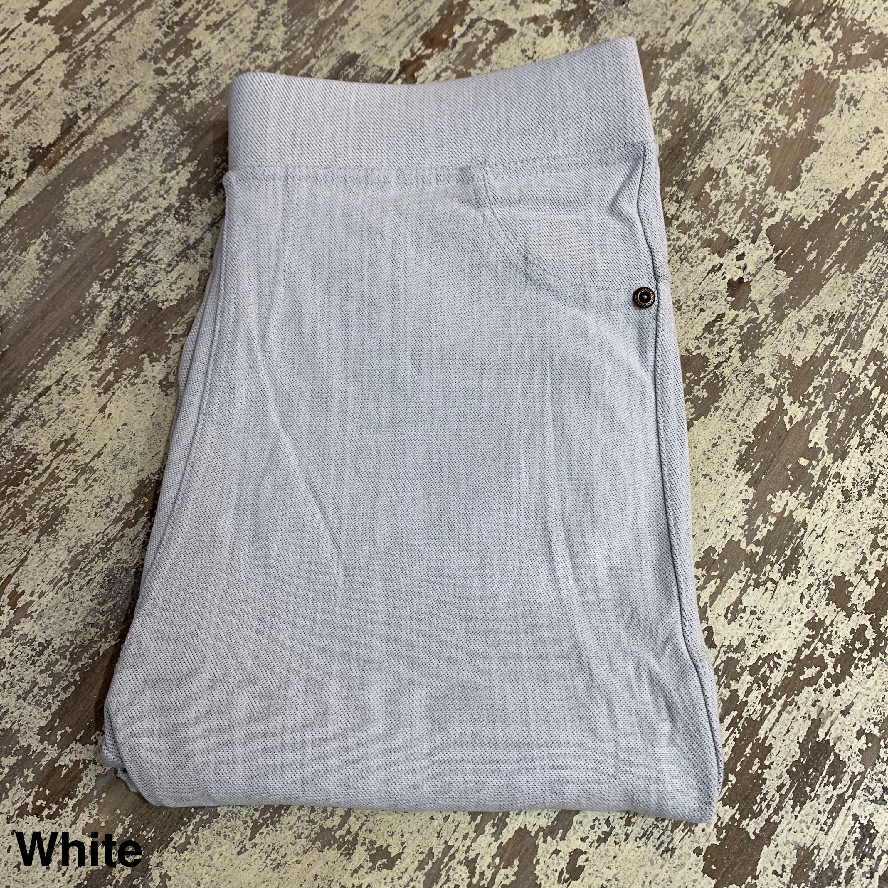 solid pull-on style leggings made of premium stretch fabric thicker than regular leggings, an elastic waistband, double back pockets, and a unique stripe detailing on the inside in white