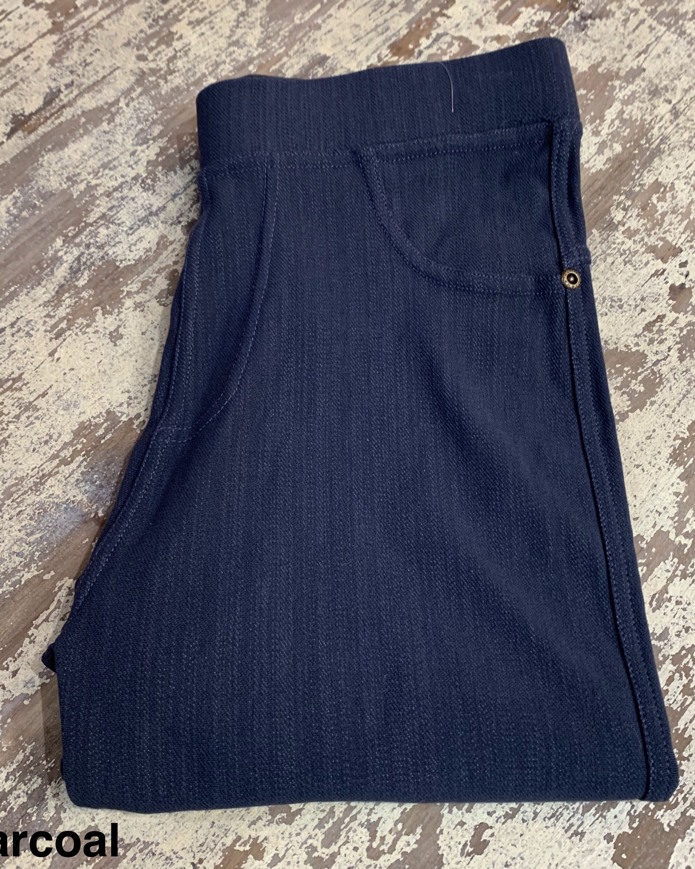 solid pull-on style leggings made of premium stretch fabric thicker than regular leggings, an elastic waistband, double back pockets, and a unique stripe detailing on the inside in charcoal