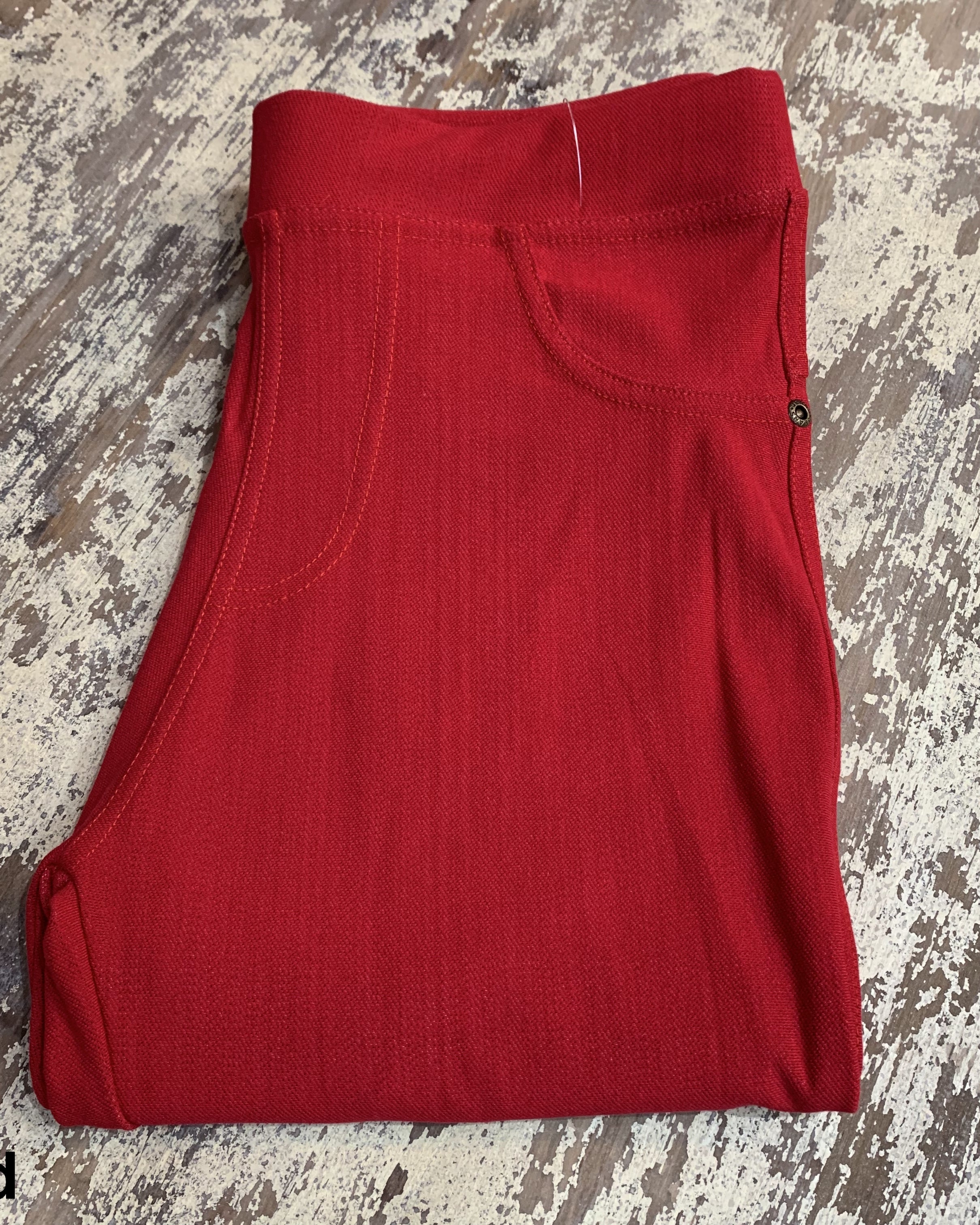 solid pull-on style leggings made of premium stretch fabric thicker than regular leggings, an elastic waistband, double back pockets, and a unique stripe detailing on the inside in red