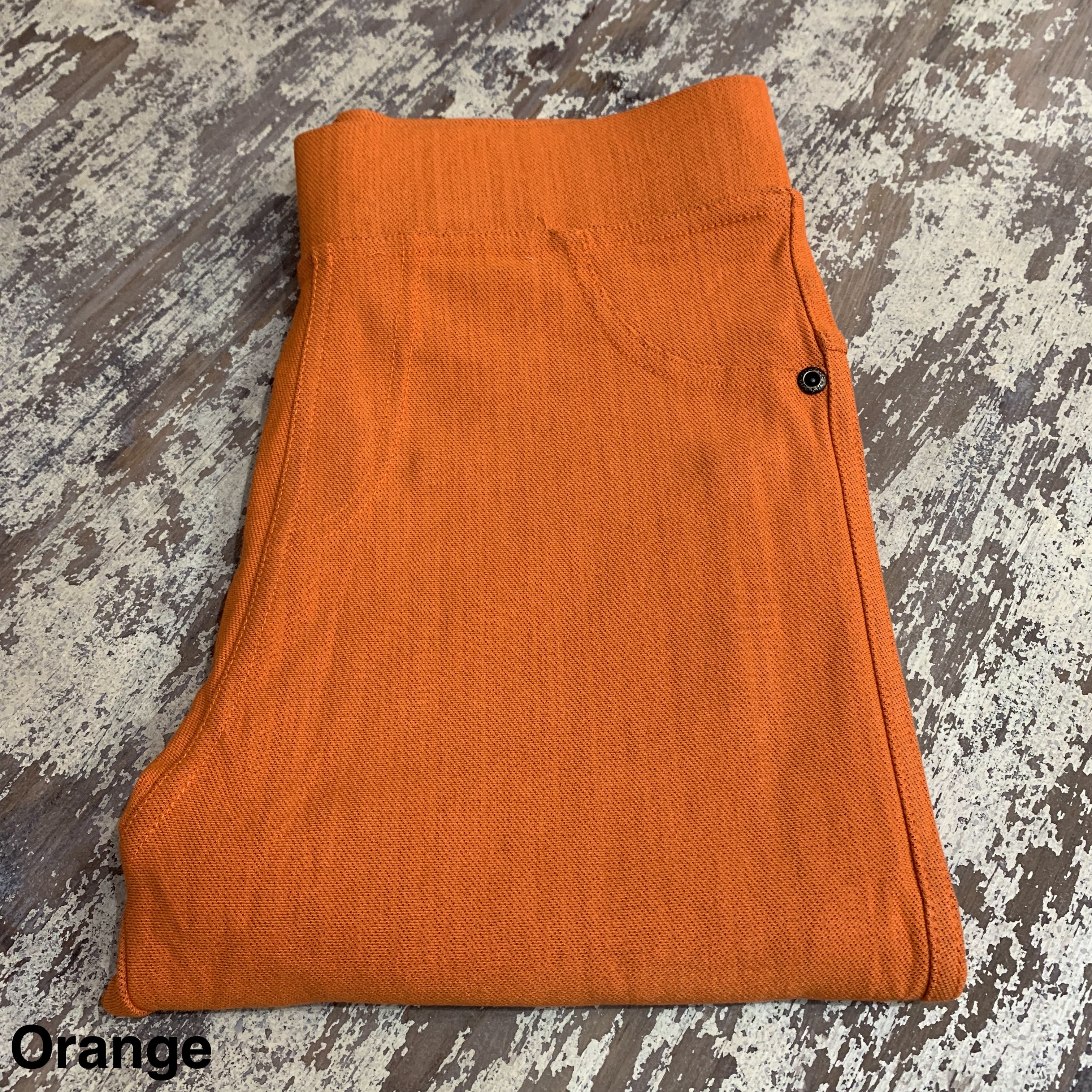 solid pull-on style leggings made of premium stretch fabric thicker than regular leggings, an elastic waistband, double back pockets, and a unique stripe detailing on the inside in orange