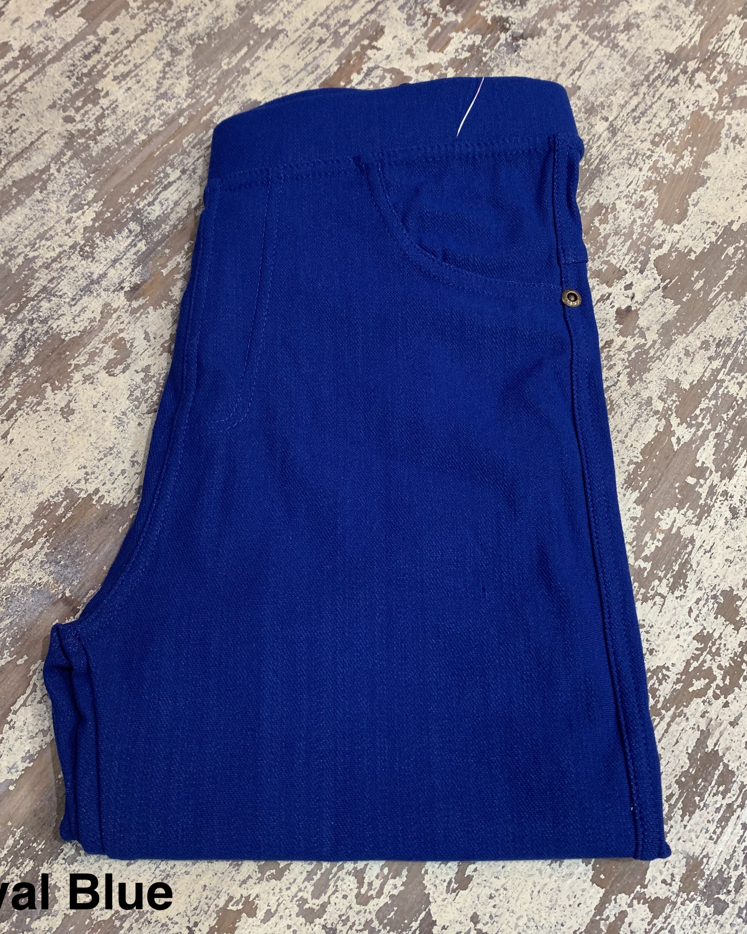 solid pull-on style leggings made of premium stretch fabric thicker than regular leggings, an elastic waistband, double back pockets, and a unique stripe detailing on the inside in royal blue