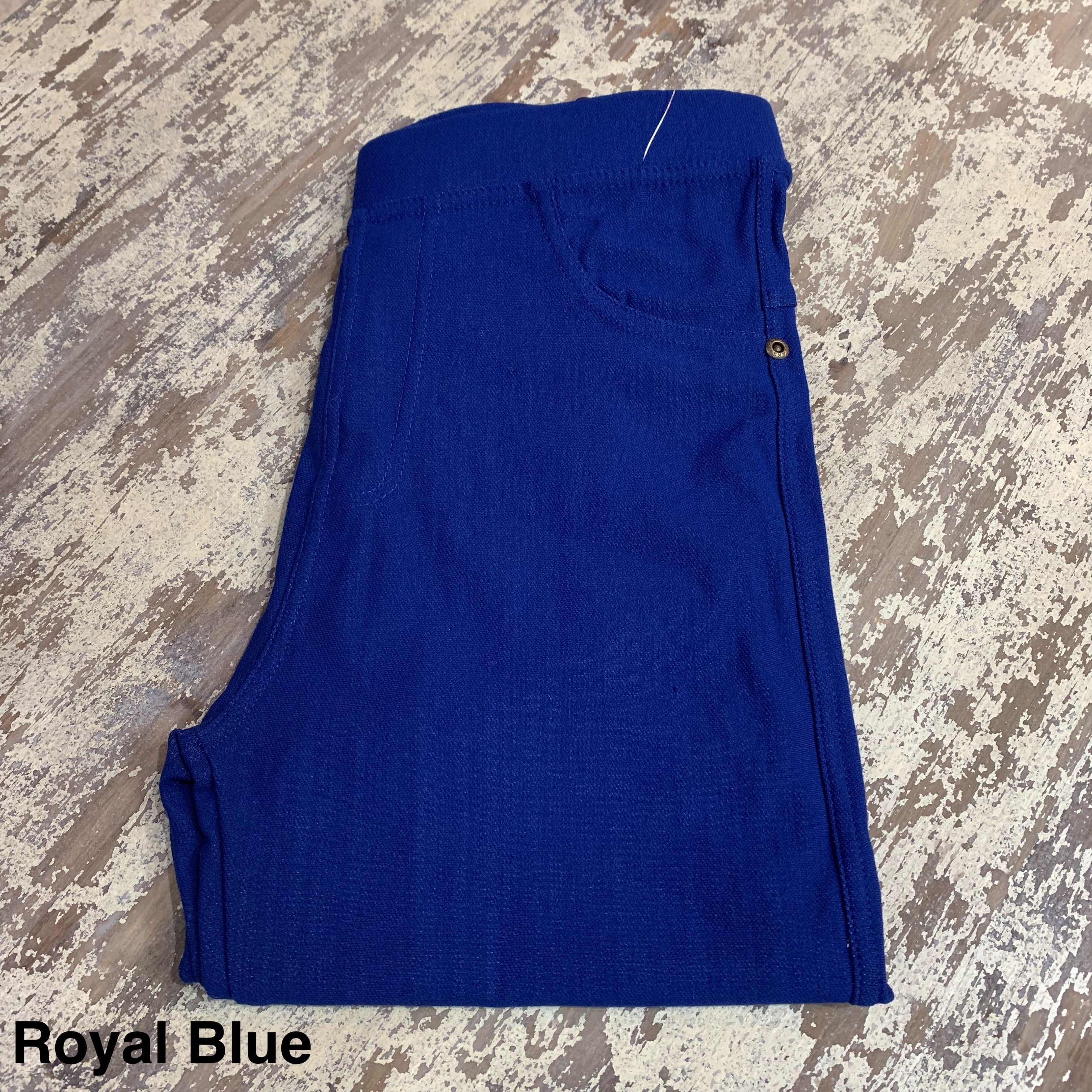 solid pull-on style leggings made of premium stretch fabric thicker than regular leggings, an elastic waistband, double back pockets, and a unique stripe detailing on the inside in royal blue