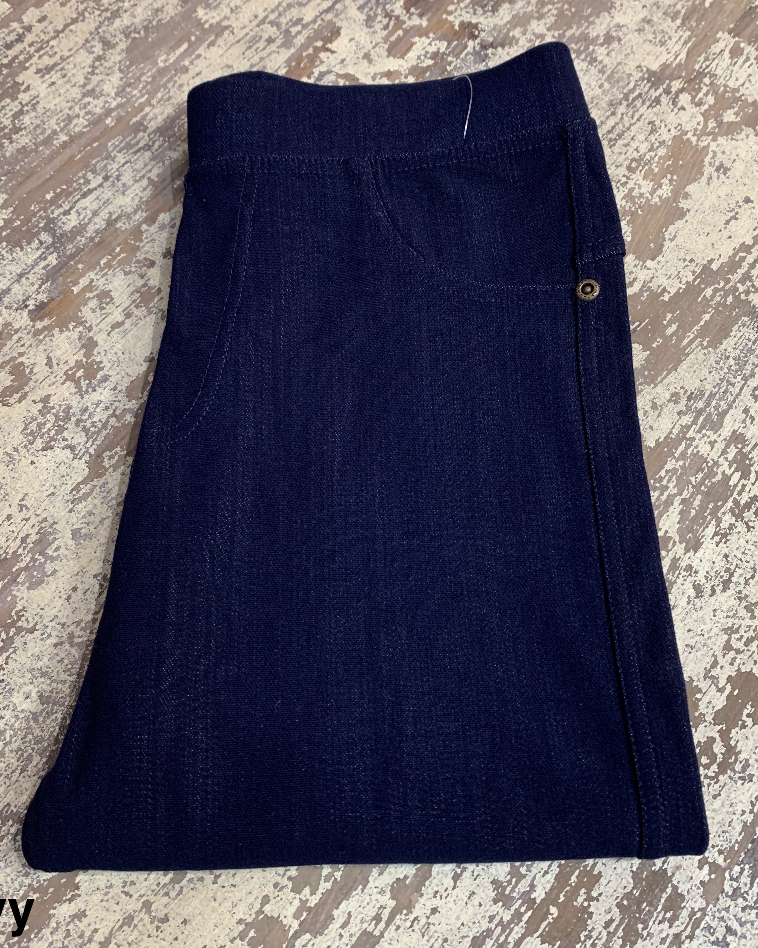 solid pull-on style leggings made of premium stretch fabric thicker than regular leggings, an elastic waistband, double back pockets, and a unique stripe detailing on the inside in navy