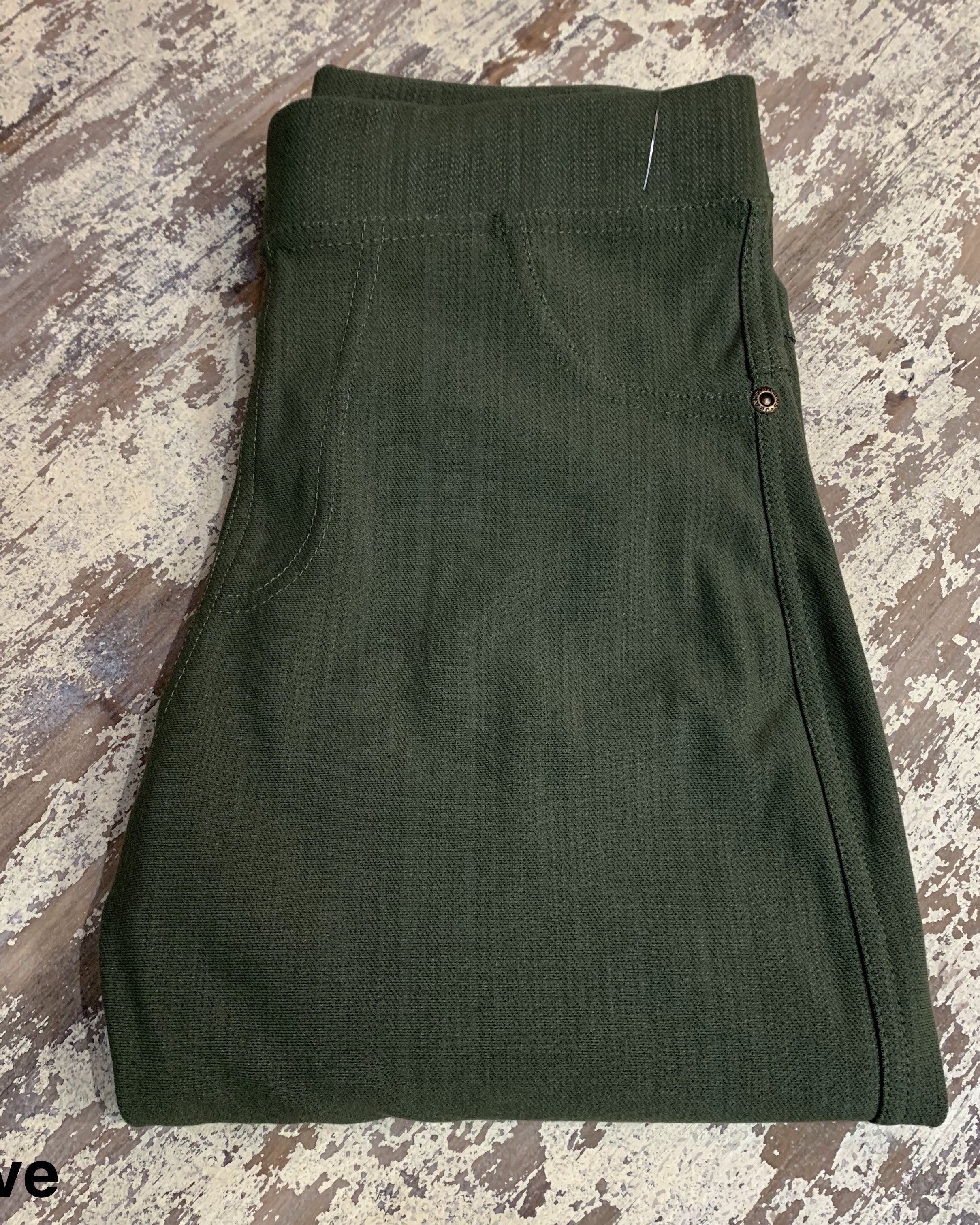 solid pull-on style leggings made of premium stretch fabric thicker than regular leggings, an elastic waistband, double back pockets, and a unique stripe detailing on the inside in olive