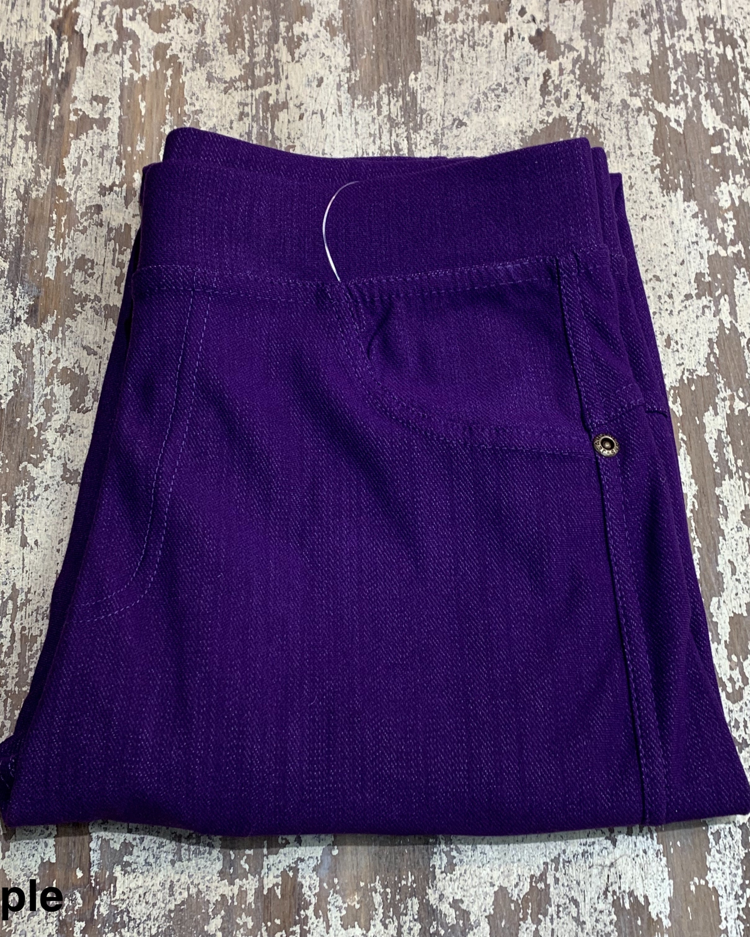 solid pull-on style leggings made of premium stretch fabric thicker than regular leggings, an elastic waistband, double back pockets, and a unique stripe detailing on the inside in purple