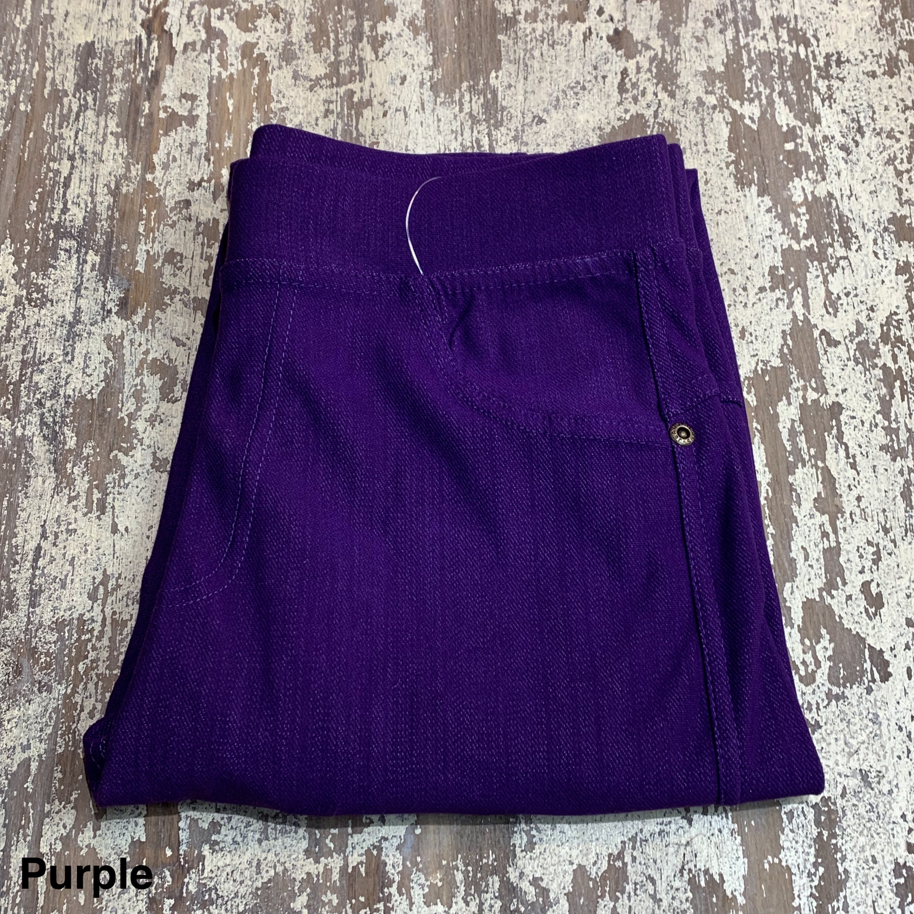 solid pull-on style leggings made of premium stretch fabric thicker than regular leggings, an elastic waistband, double back pockets, and a unique stripe detailing on the inside in purple