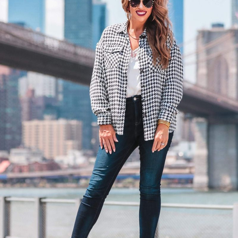 long sleeve drop shoulder shacket with button closures, a button-down front, a collared neckline, chest pockets, and back detailing on a black and white houndstooth print