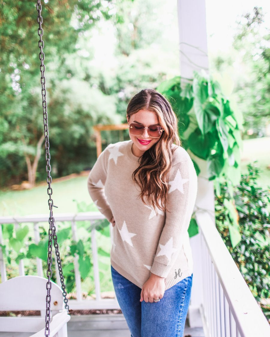 long-sleeve sweater crafted from soft knitted material with a crew neckline on a white star pattern print and a solid taupe base