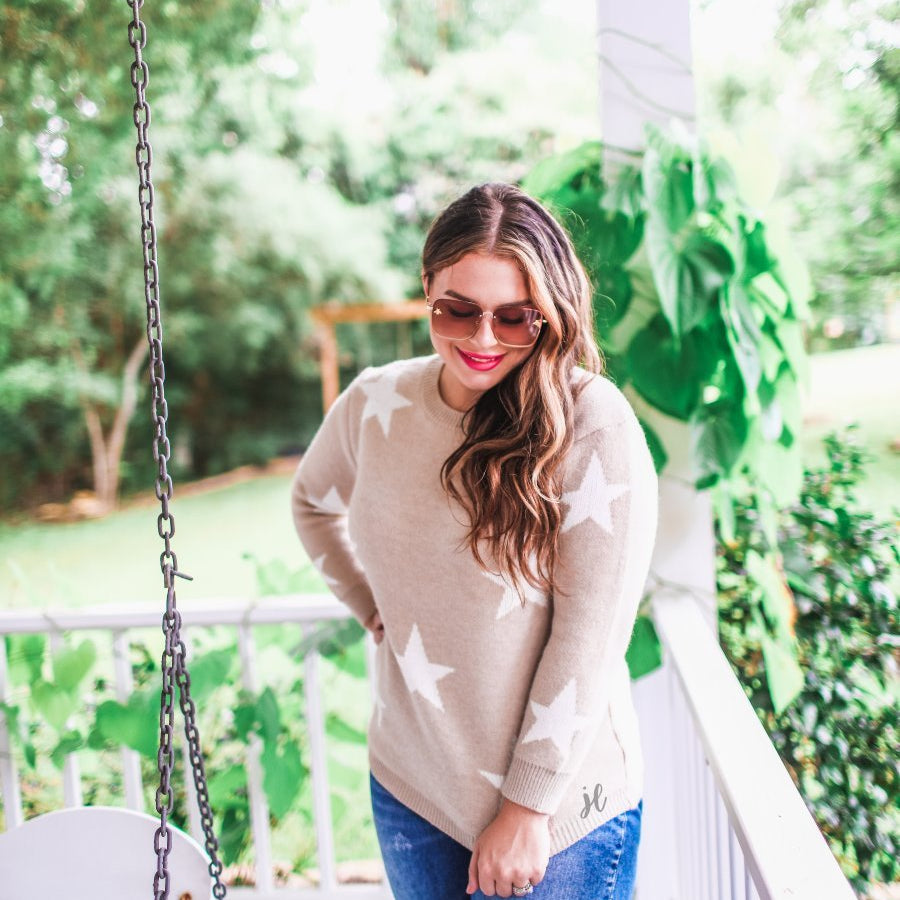 long-sleeve sweater crafted from soft knitted material with a crew neckline on a white star pattern print and a solid taupe base
