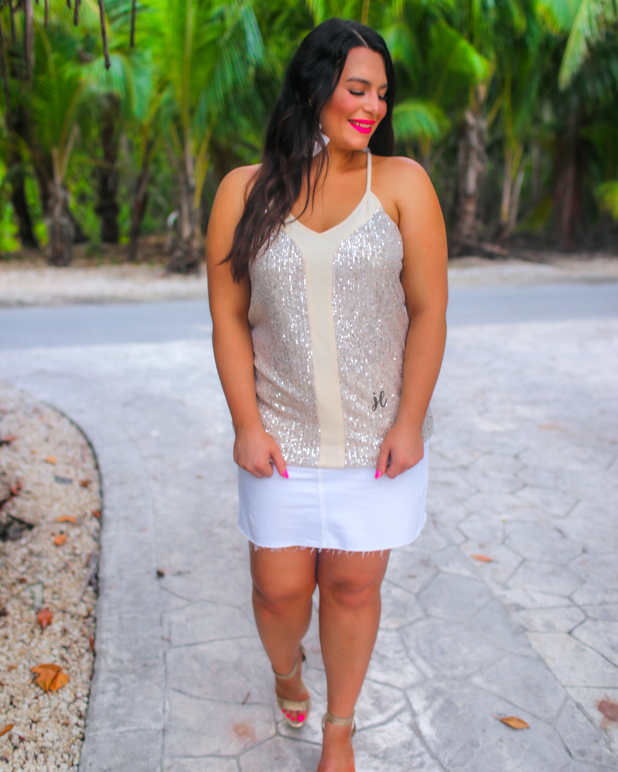 an adjustable strap racerback style sleeveless cami with a v-neckline on a sequin fabric in champagne
