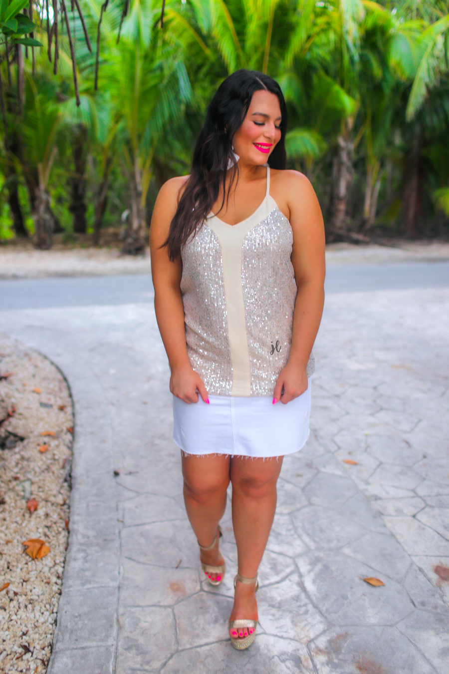 an adjustable strap racerback style sleeveless cami with a v-neckline on a sequin fabric in champagne