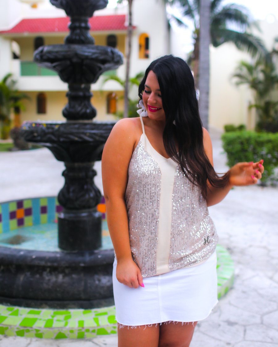 an adjustable strap racerback style sleeveless cami with a v-neckline on a sequin fabric in champagne