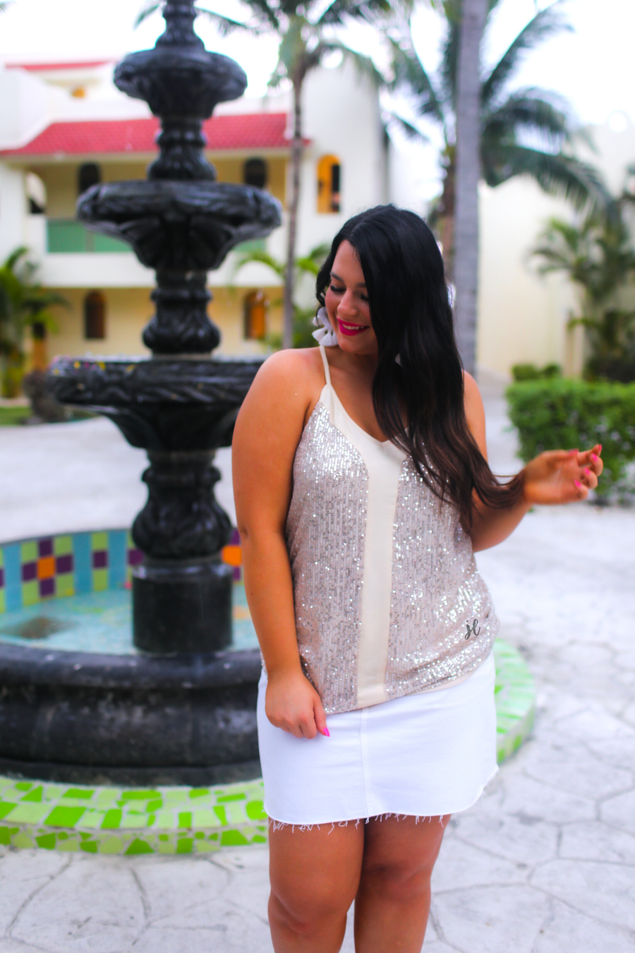 an adjustable strap racerback style sleeveless cami with a v-neckline on a sequin fabric in champagne