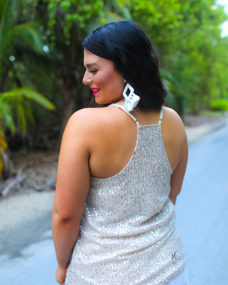 an adjustable strap racerback style sleeveless cami with a v-neckline on a sequin fabric in champagne