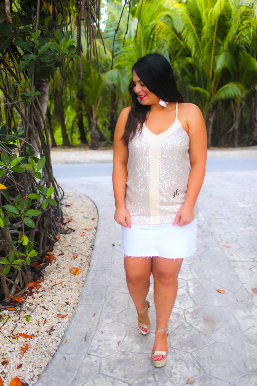 an adjustable strap racerback style sleeveless cami with a v-neckline on a sequin fabric in champagne