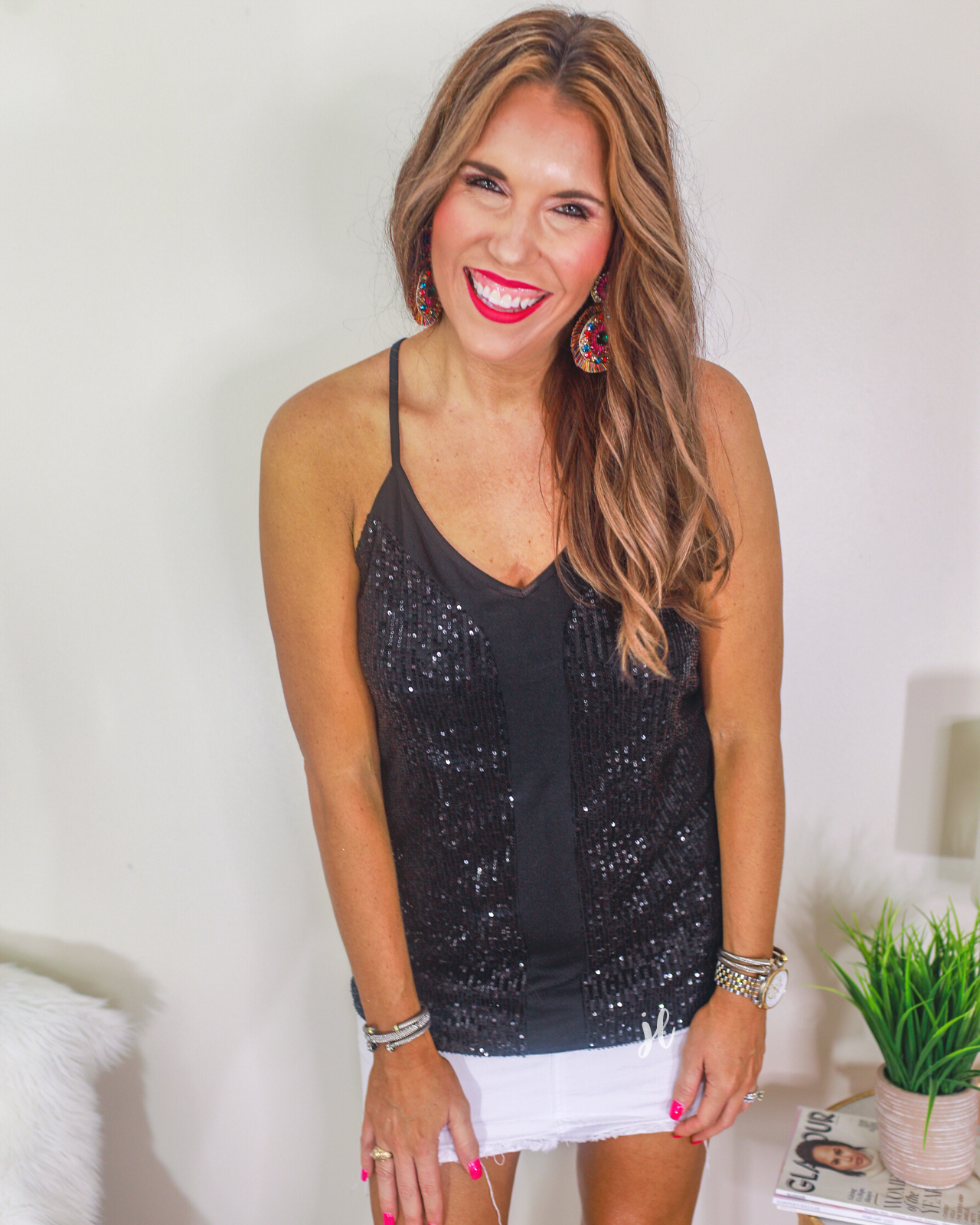 an adjustable strap racerback style sleeveless cami with a v-neckline on a sequin fabric in black