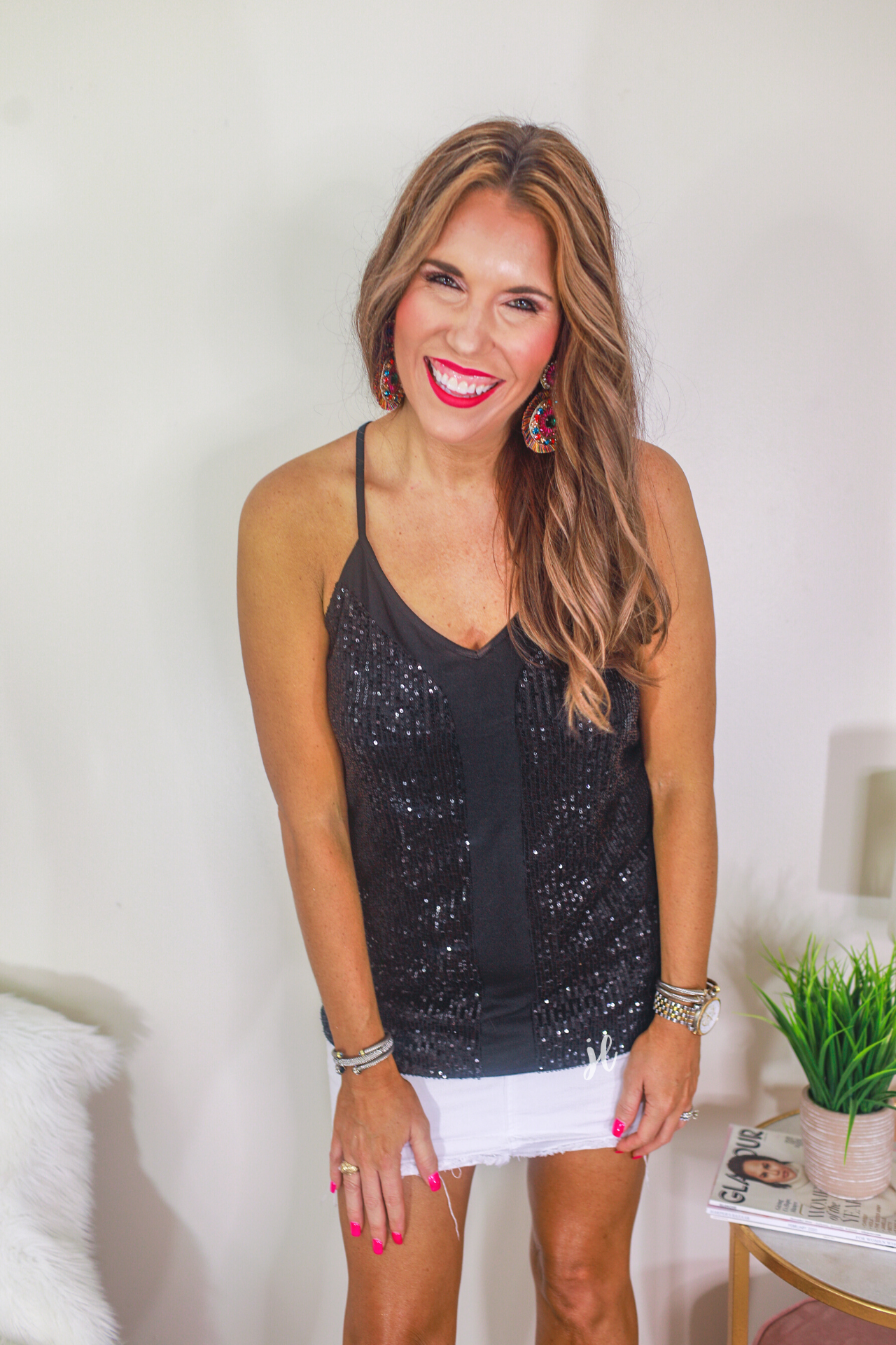 an adjustable strap racerback style sleeveless cami with a v-neckline on a sequin fabric in black