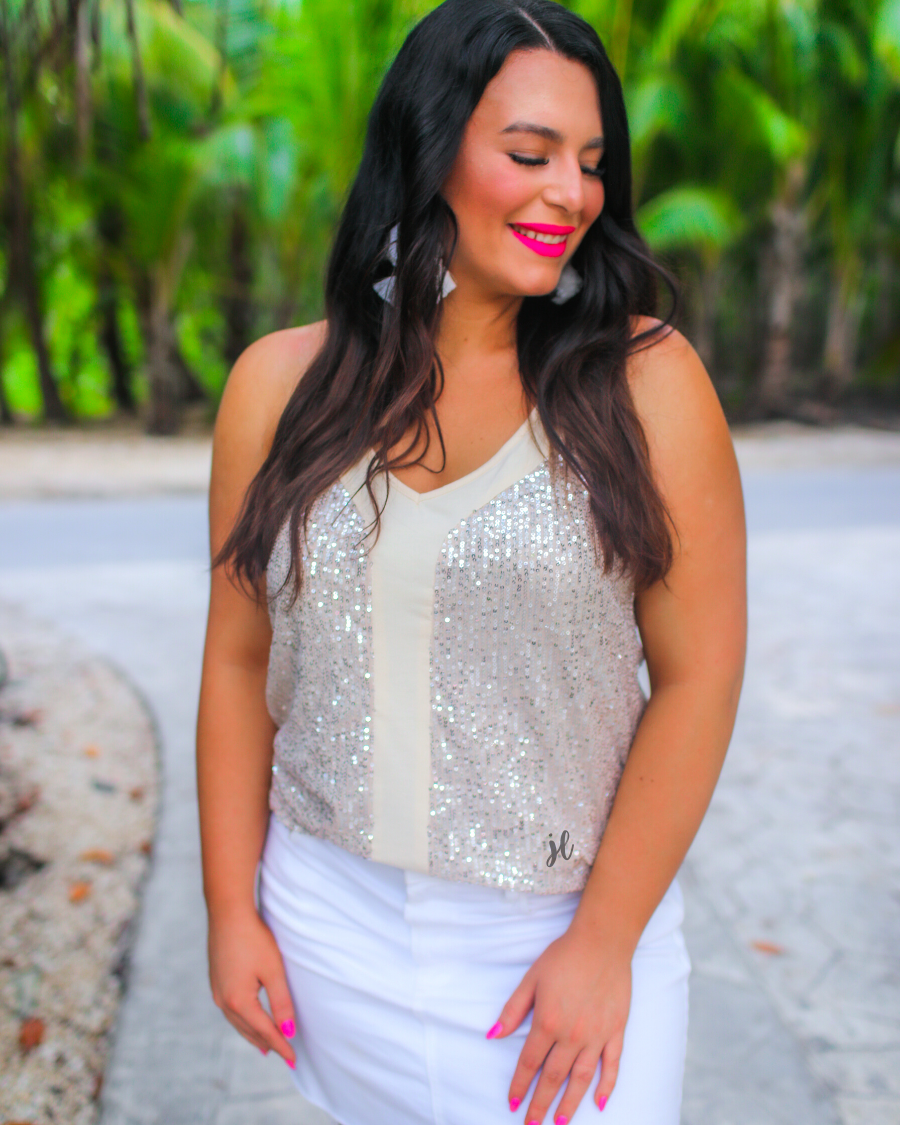 an adjustable strap racerback style sleeveless cami with a v-neckline on a sequin fabric in champagne