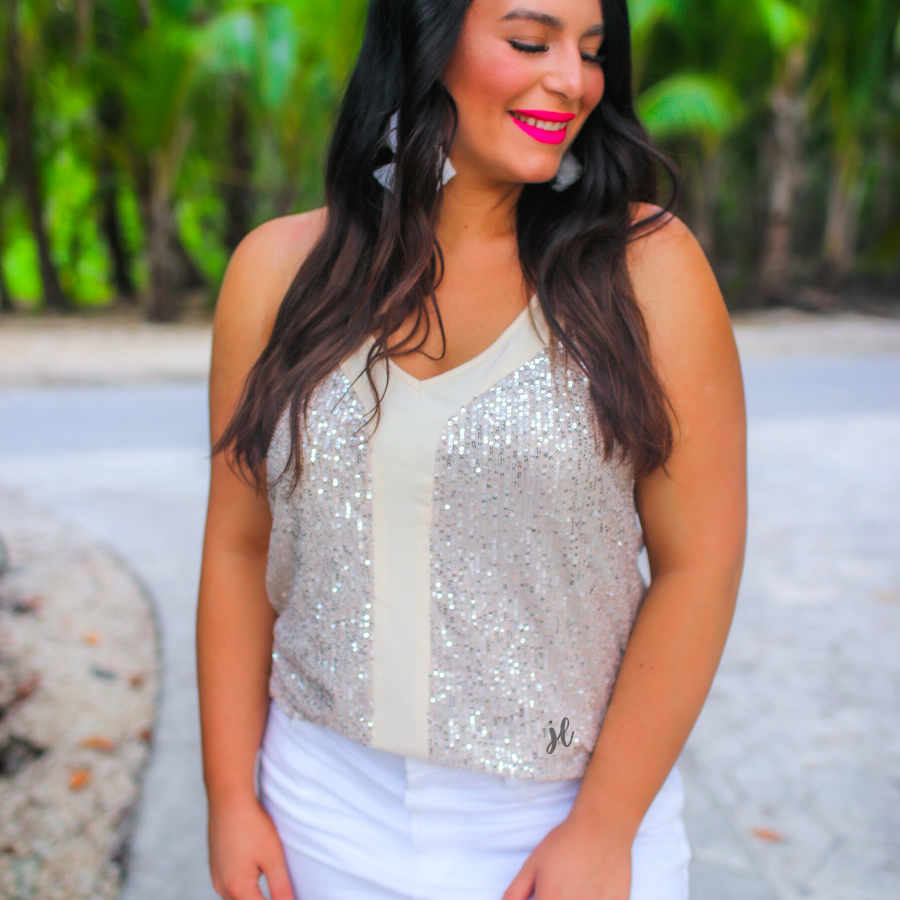 an adjustable strap racerback style sleeveless cami with a v-neckline on a sequin fabric in champagne