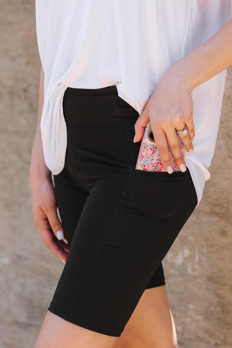 sleek black biker shorts crafted from lightweight stretch fabric with a high elastic waistband for tummy control, side pockets, a flattering figure-hugging short silhouette, above-knee length, and pull-on design Shorts BRITTANY