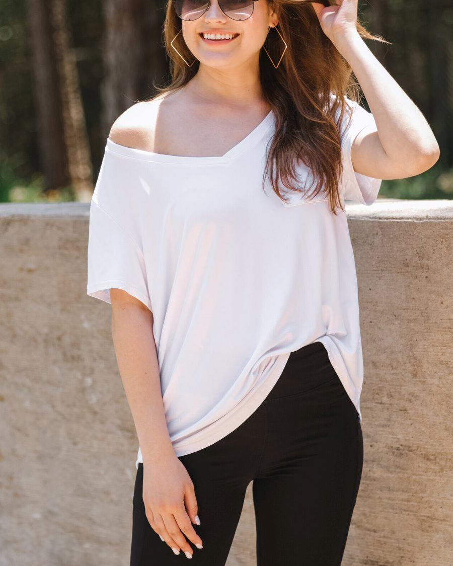 sleek black biker shorts crafted from lightweight stretch fabric with a high elastic waistband for tummy control, side pockets, a flattering figure-hugging short silhouette, above-knee length, and pull-on design