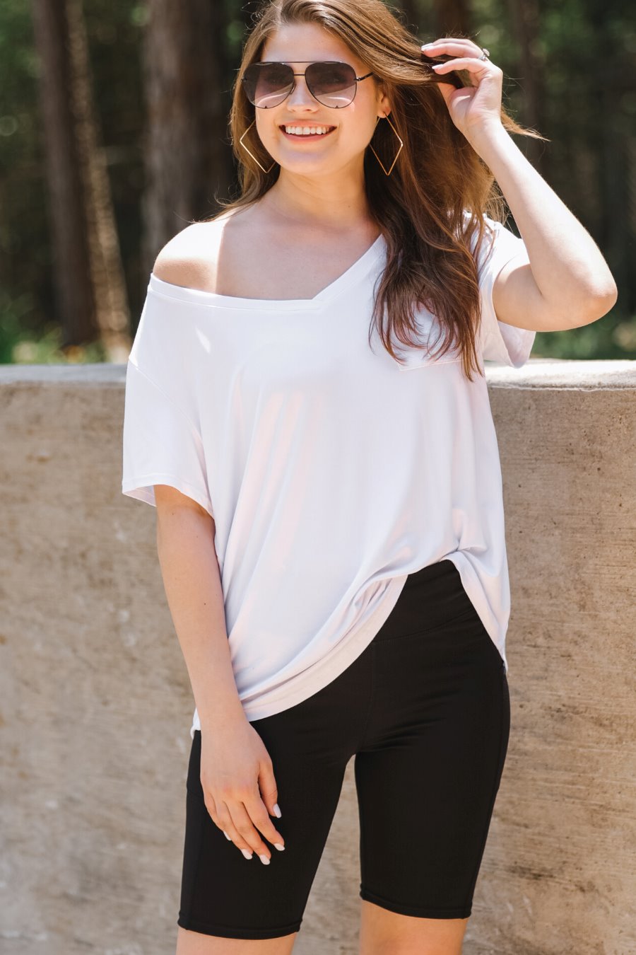 sleek black biker shorts crafted from lightweight stretch fabric with a high elastic waistband for tummy control, side pockets, a flattering figure-hugging short silhouette, above-knee length, and pull-on design