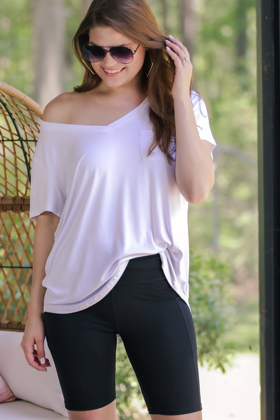 sleek black biker shorts crafted from lightweight stretch fabric with a high elastic waistband for tummy control, side pockets, a flattering figure-hugging short silhouette, above-knee length, and pull-on design