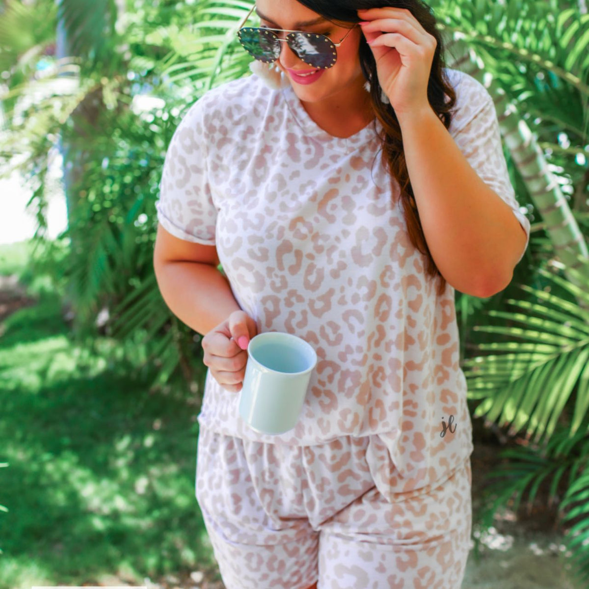 a neutral taupe animal print lounge set crafted from soft stretch fabric with a short-sleeve V-neck top, matching pull-on shorts, elastic waistband, side pockets, and relaxed fit, accented with a MADE IN USA watermark in the bottom left-hand corner
