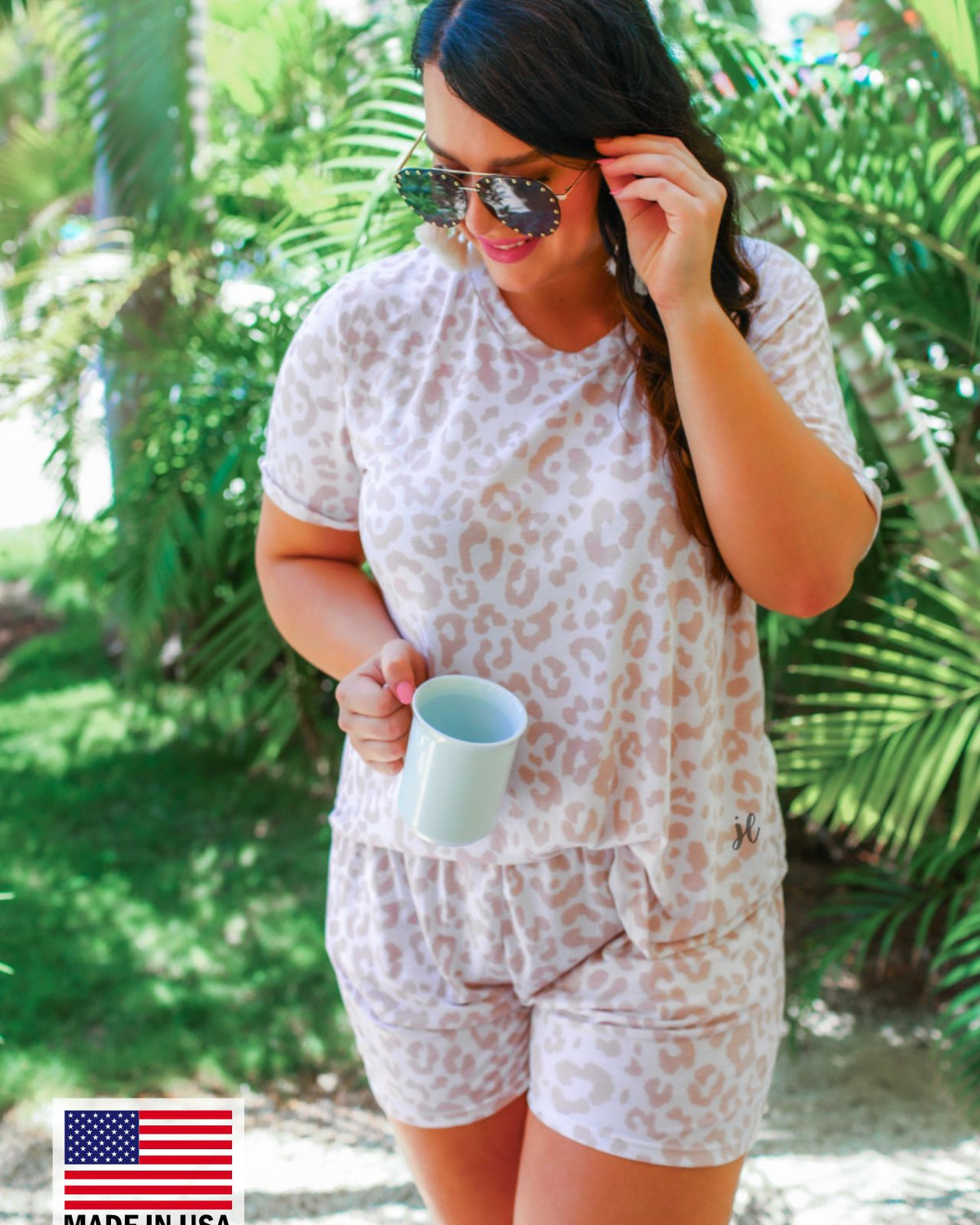 a neutral taupe animal print lounge set crafted from soft stretch fabric with a short-sleeve V-neck top, matching pull-on shorts, elastic waistband, side pockets, and relaxed fit, accented with a MADE IN USA watermark in the bottom left-hand corner