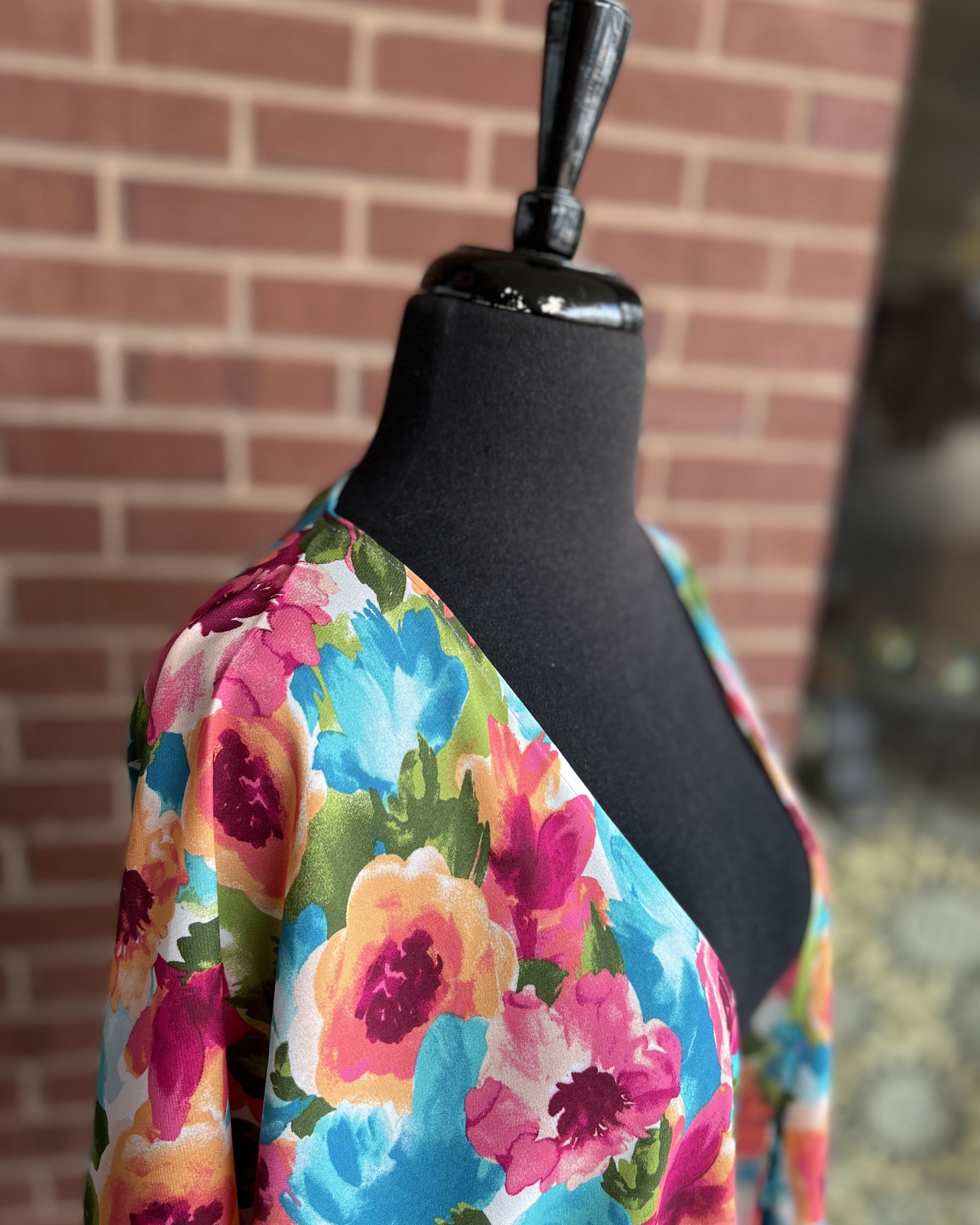 a flowy style open front kimono made of lightweight material with half sleeves on an exclusive vibrant multicolor floral pattern fabric