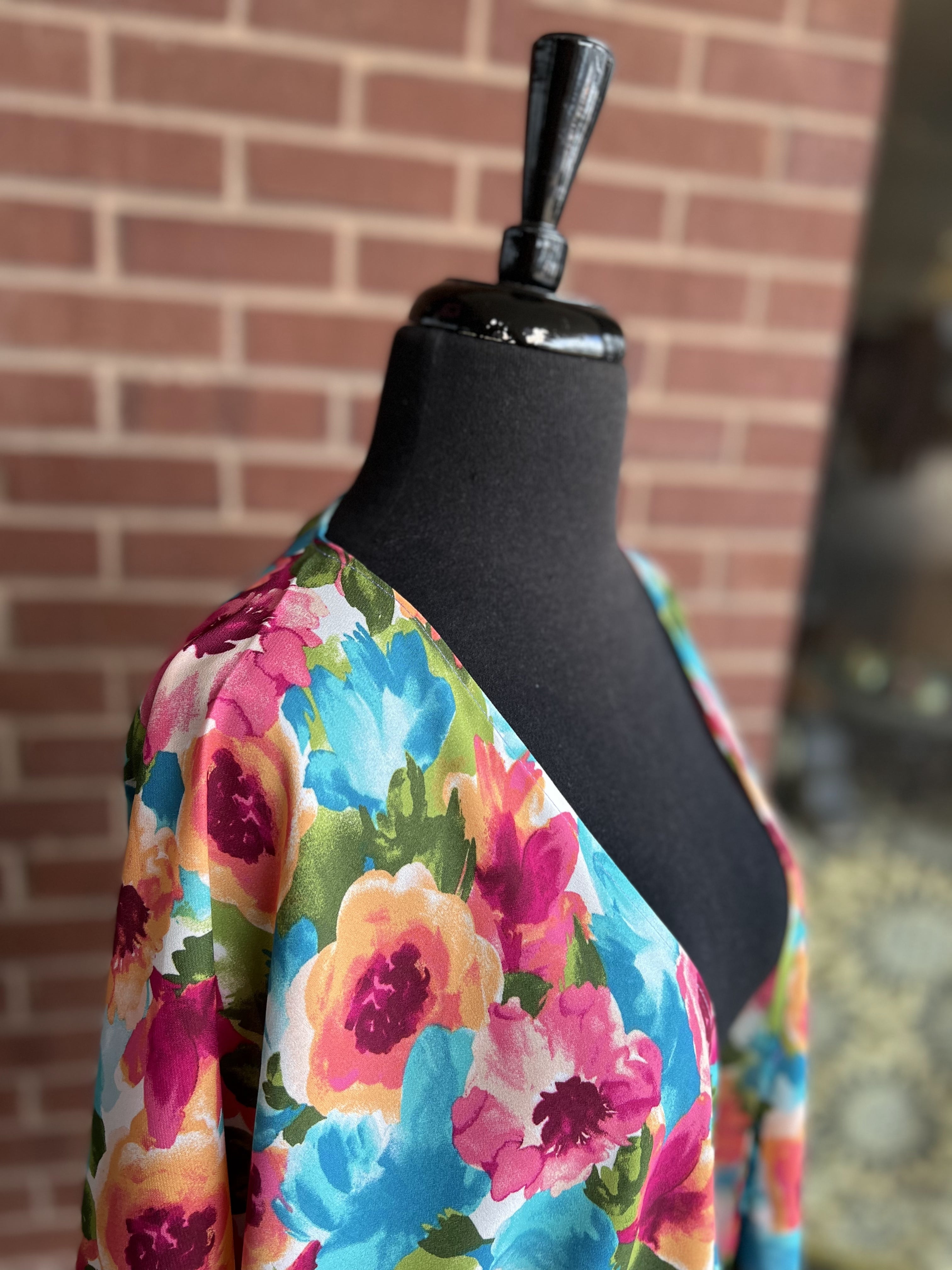 a flowy style open front kimono made of lightweight material with half sleeves on an exclusive vibrant multicolor floral pattern fabric