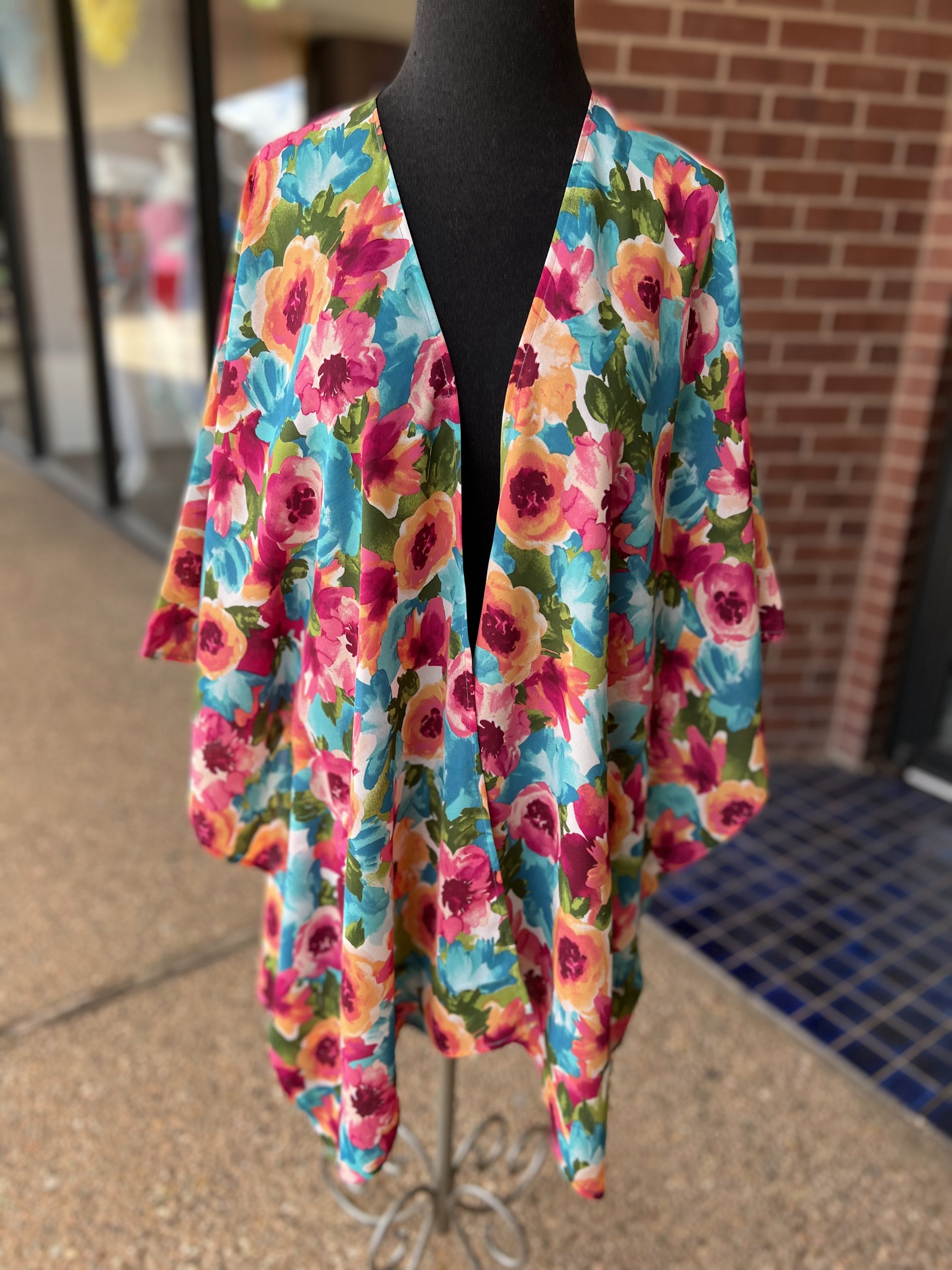 a flowy style open front kimono made of lightweight material with half sleeves on an exclusive vibrant multicolor floral pattern fabric