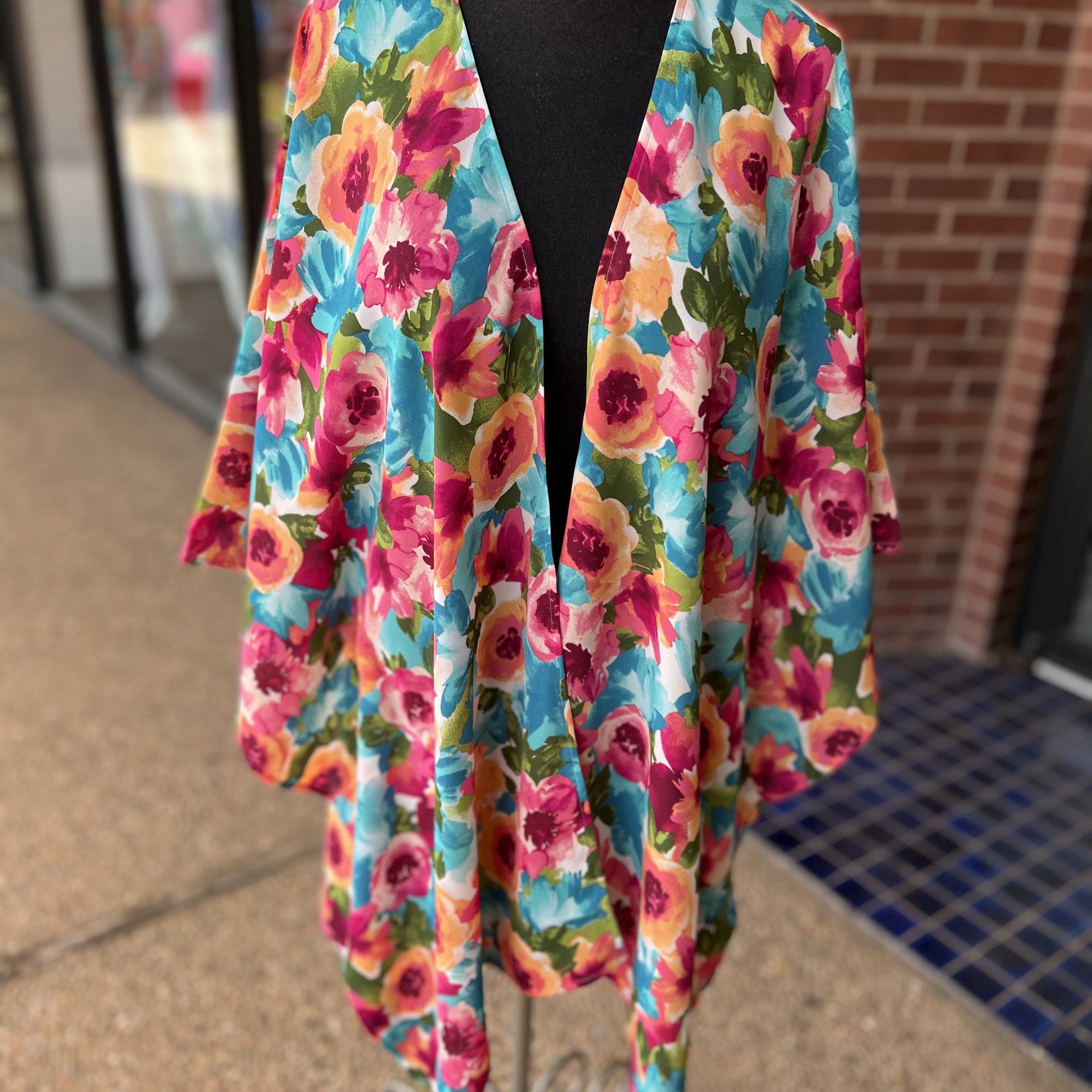 a flowy style open front kimono made of lightweight material with half sleeves on an exclusive vibrant multicolor floral pattern fabric