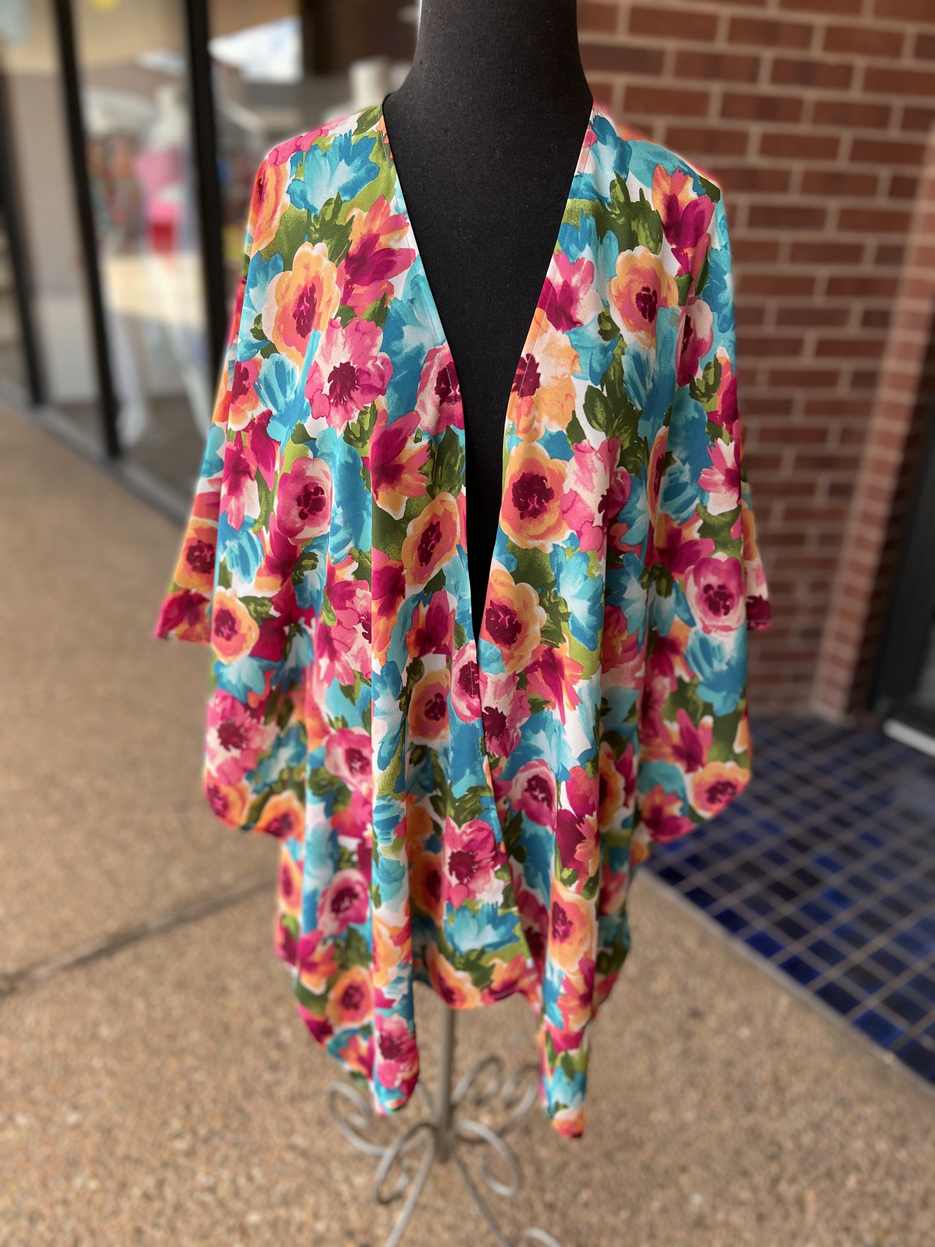 a flowy style open front kimono made of lightweight material with half sleeves on an exclusive vibrant multicolor floral pattern fabric